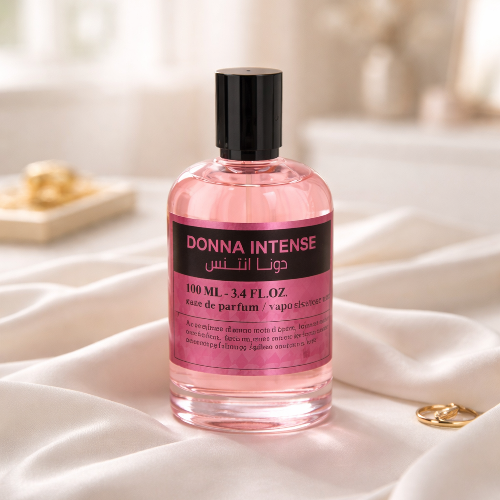 Pink perfume bottle labeled 'Donna Intense' on a soft white surface with a blurred background.