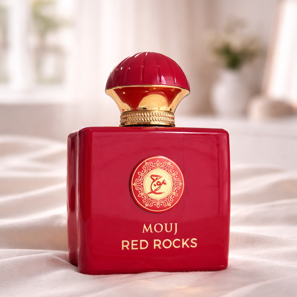 Red perfume bottle labeled 'Mouj Red Rocks' on a white surface