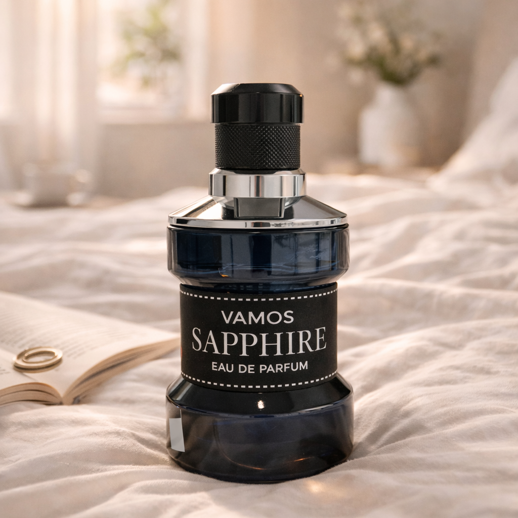 Vamos Sapphire eau de parfum bottle on a bed with soft lighting
