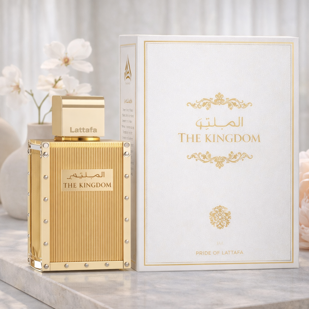 Gold perfume bottle and packaging with decorative elements on a light background