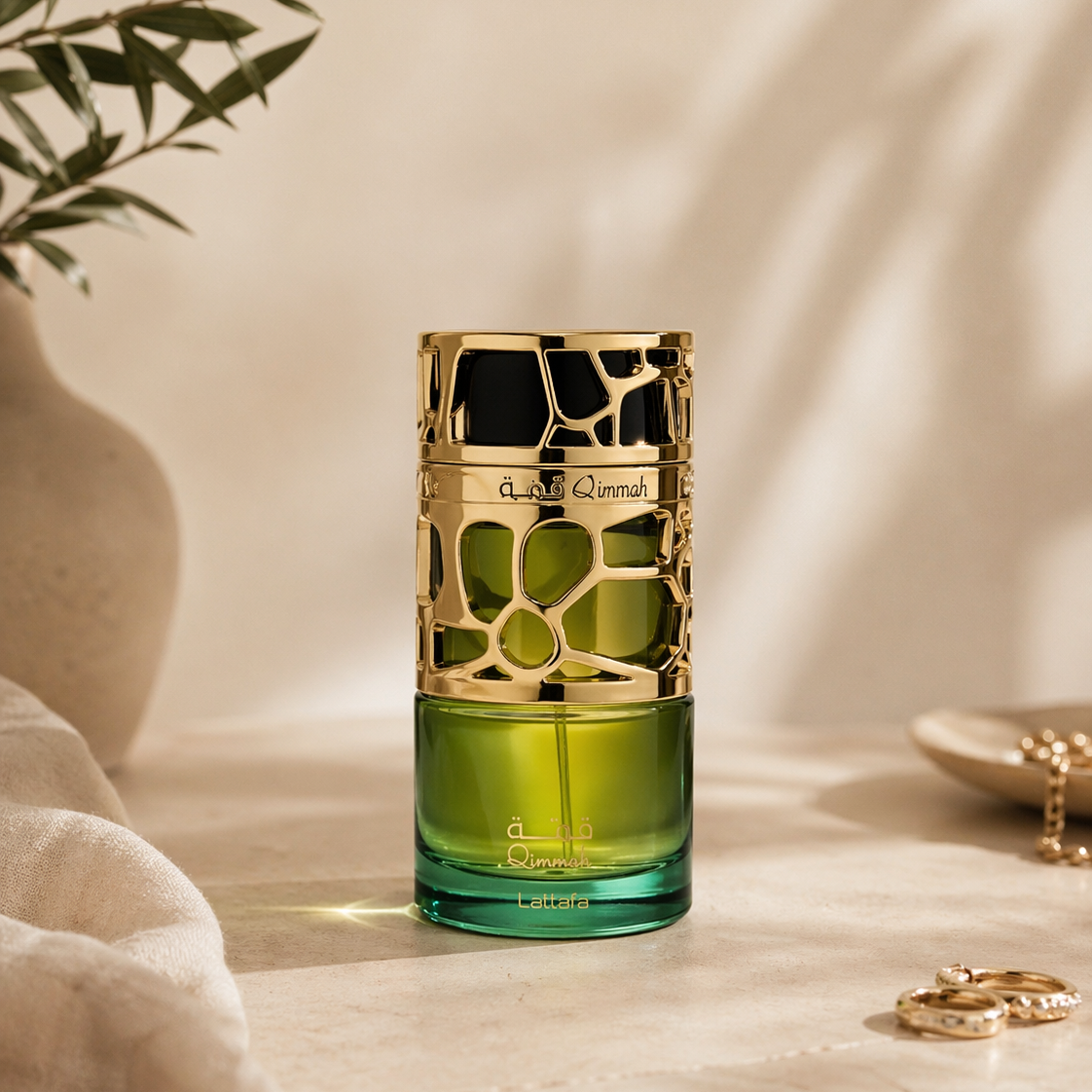 Green perfume bottle with gold cap on a neutral background