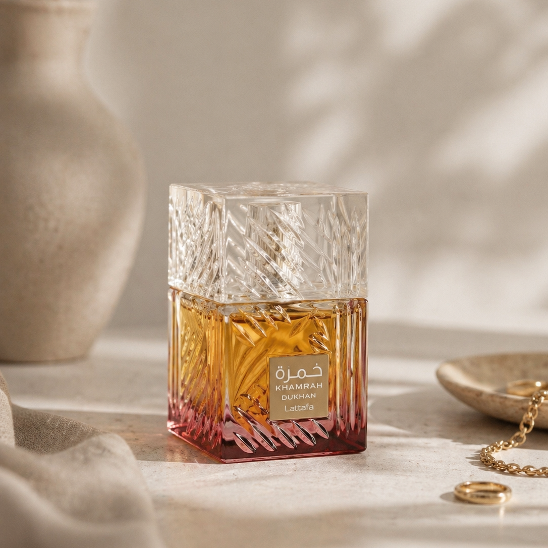 Glass container with a gold label on a light surface with a neutral background